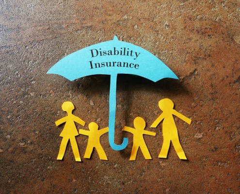 Paper family of four under a paper Disability Insurance umbrella