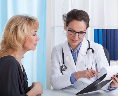 Doctor showing patient test results in office